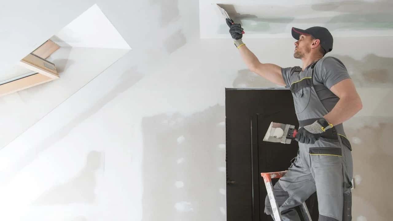 Drywall installer working in a Gloucester home