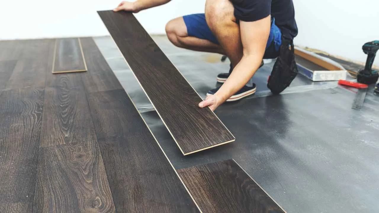 Professional installing commercial flooring in Ottawa office space