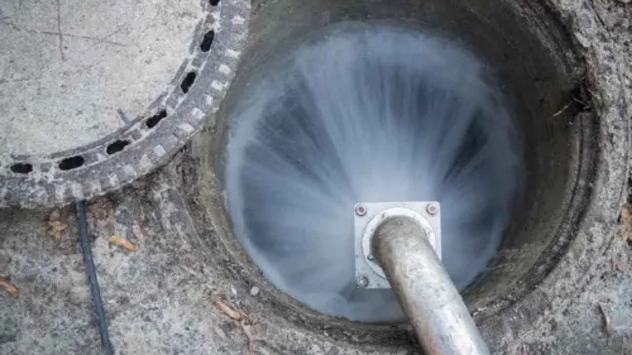 Plumber using hydro jetting equipment to clean sewer line in Ottawa home